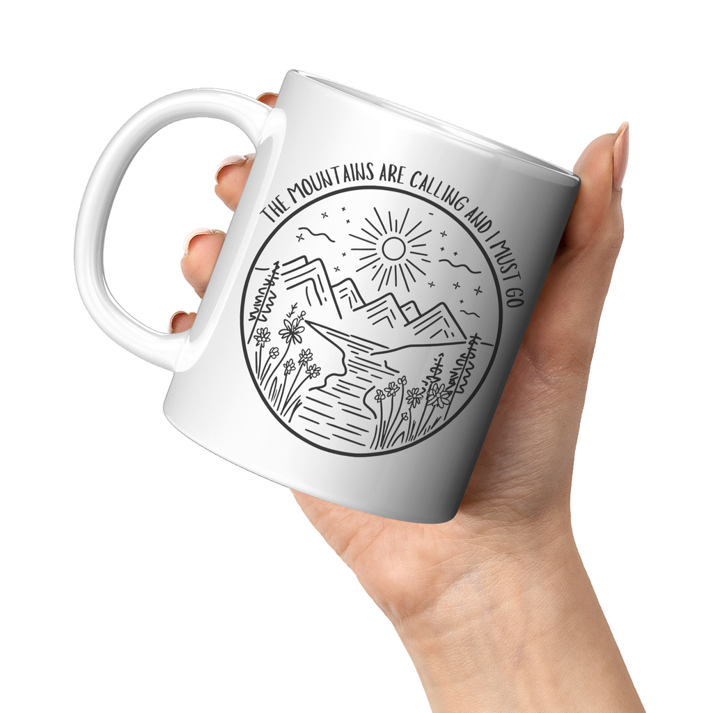 The_Mountains_Are_Calling_and_I_Must_Go__11oz_White_LH_Model_Mockup.png